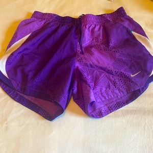 Small purple and white silk Nike shorts.